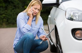 Female Motorist Phoning For Help After Breakdown